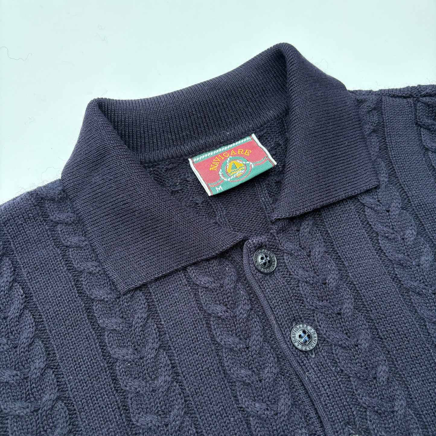 Polo in maglia a trecce